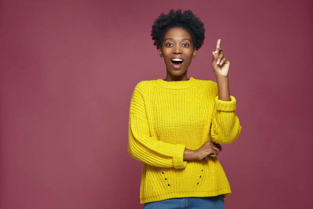 Happy african american girl student created idea, feel insight raised forefinger up on pink studio background, copyspace. High quality photo