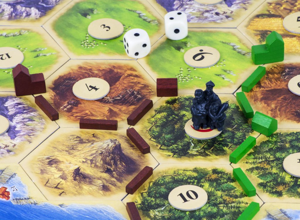 Darlington, England - April 15, 2016: The concept of different choices of buying a home and the dangers (represented by the thieves) of owning one, illustrated with the help of the popular board game <a href=