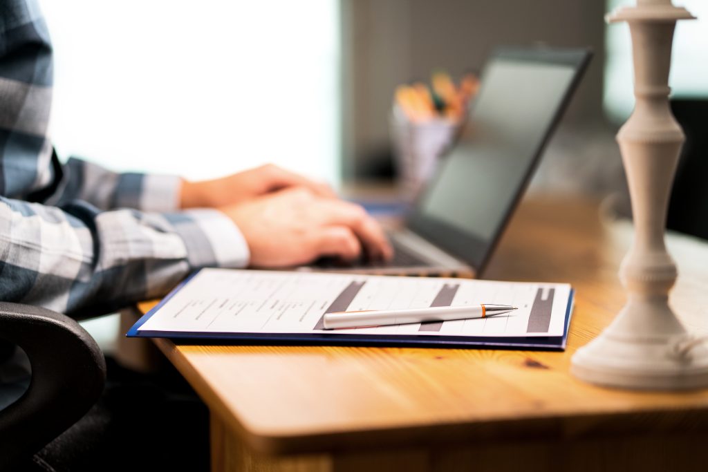 Survey form, customer satisfaction feedback poll, resume for job application or for college. Man writing with laptop. Home or car insurance contract. <a href=
