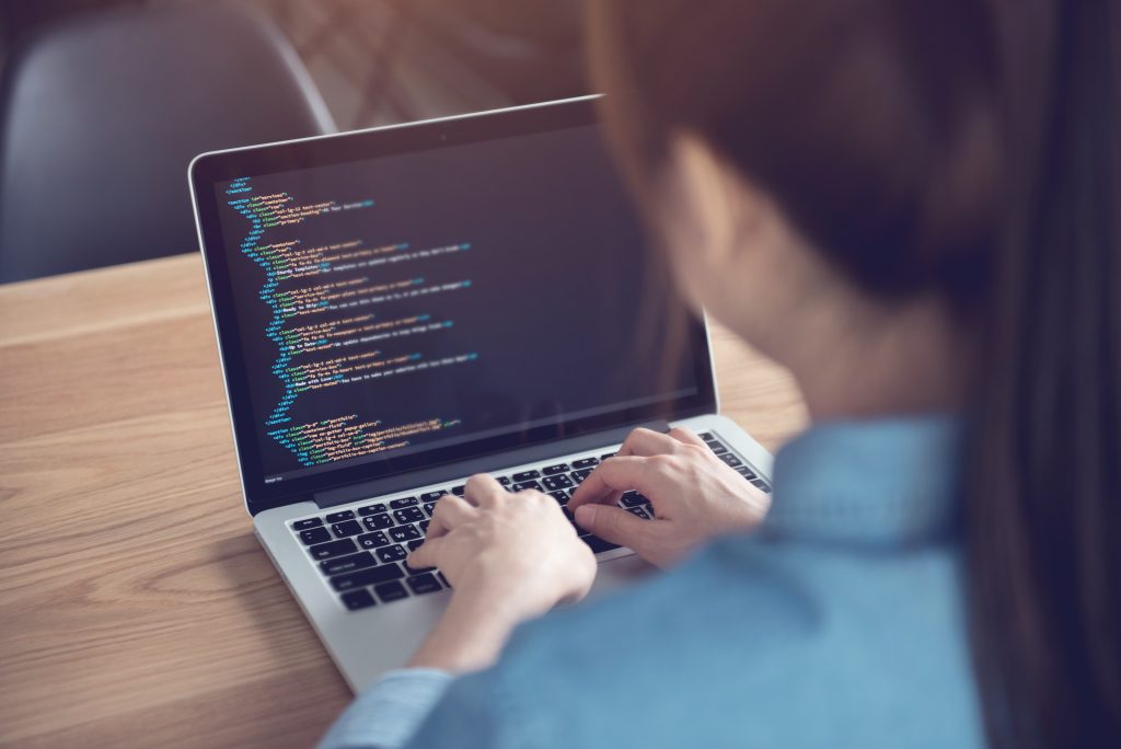 Closeup coding on screen, Woman hands coding html and programming on screen laptop, development web, developer.