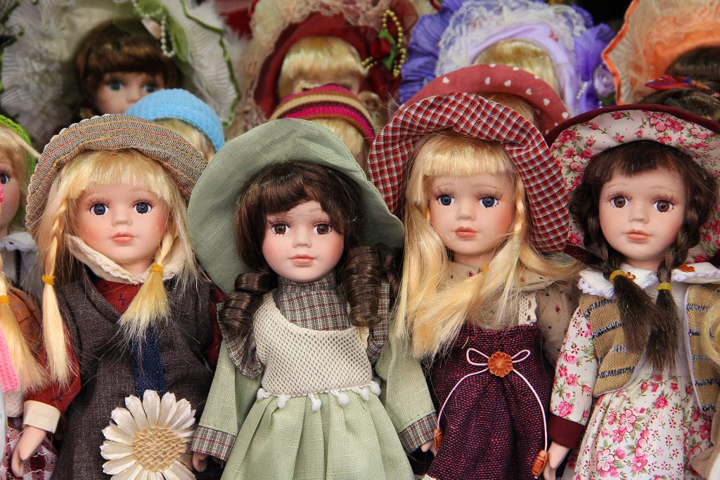 Porcelain dolls for children, dressed withcolorful hats and dresses in Prague market, sold as souvenirs.