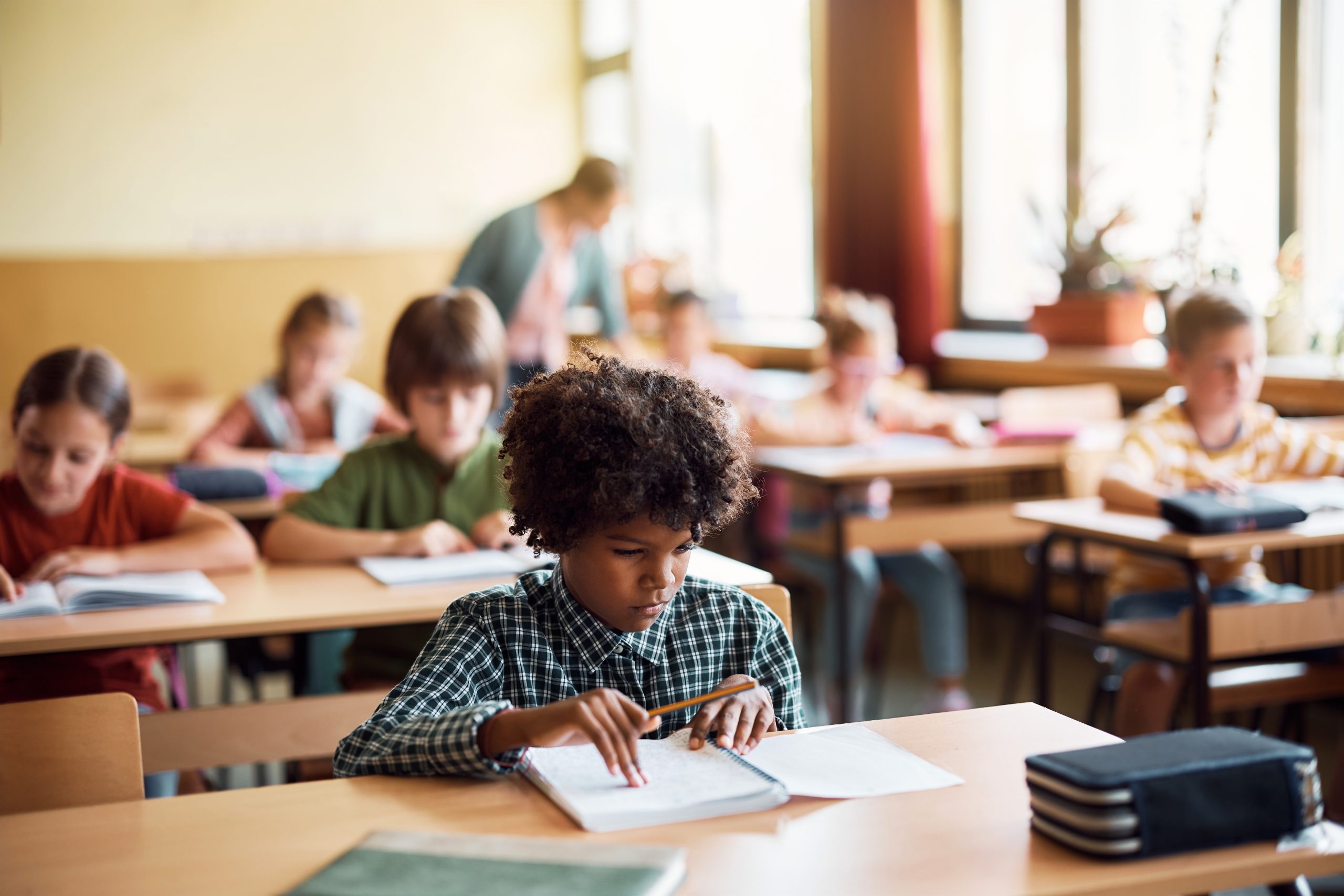 African American elementary student learning during a class in the classroom.