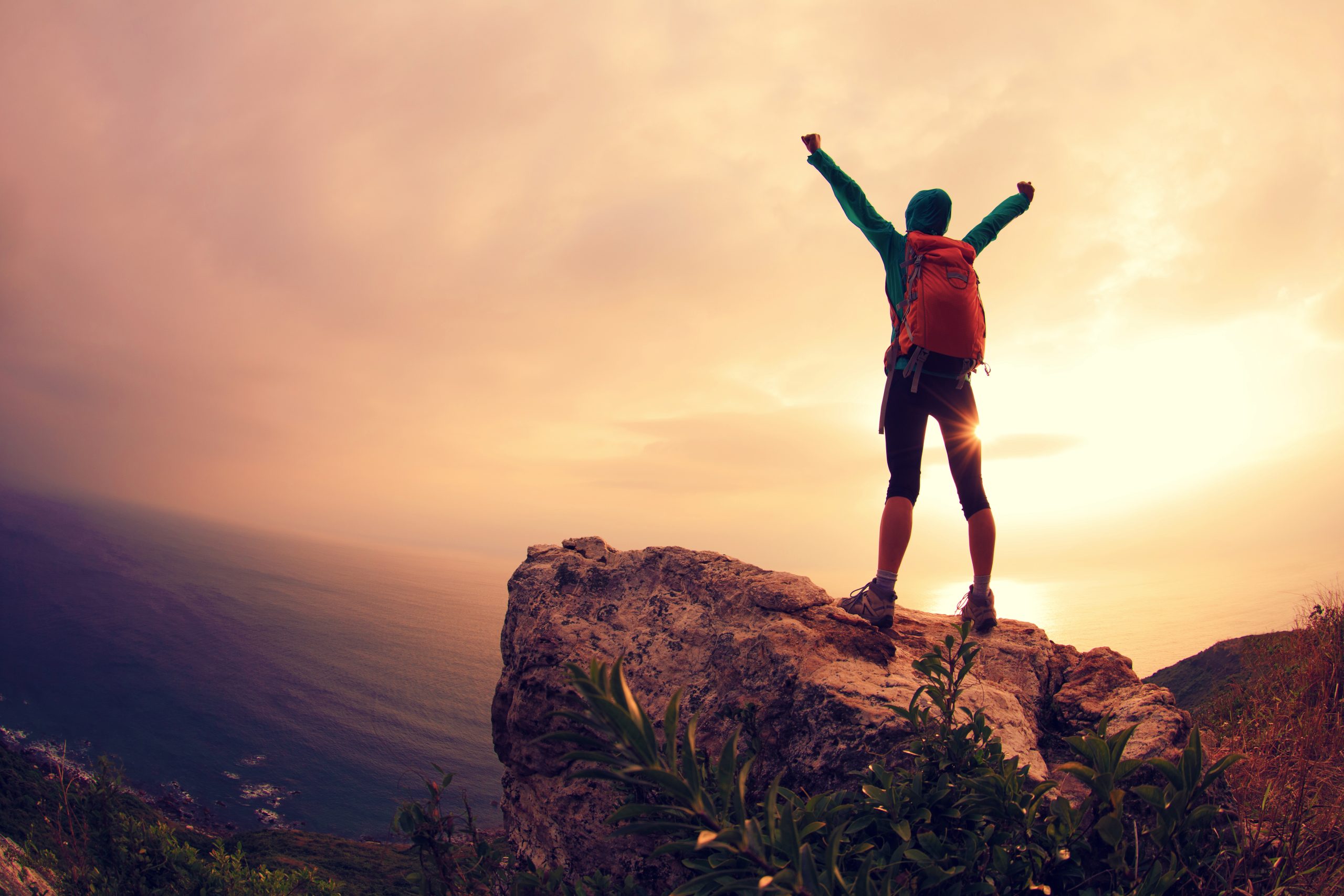 successful hiker hiking on seaside mountain peak